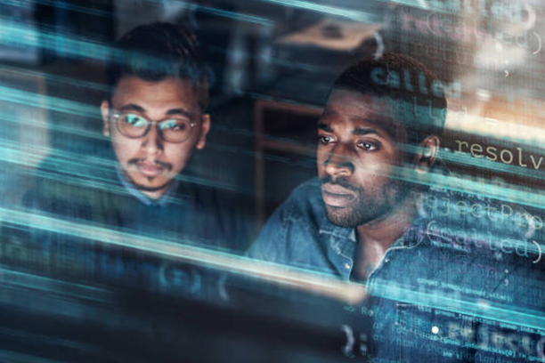 Full length portrait of two contemporary businessmen laying documents on floor while planning startup project in loft styled office, copy space